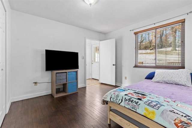 bedroom featuring dark wood-style flooring and baseboards