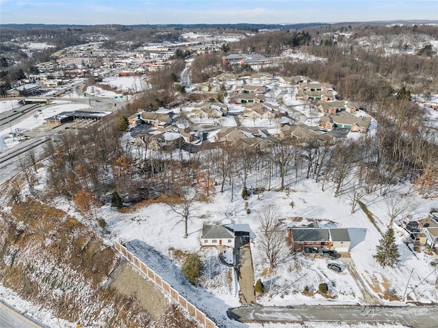 snowy aerial view with a residential view