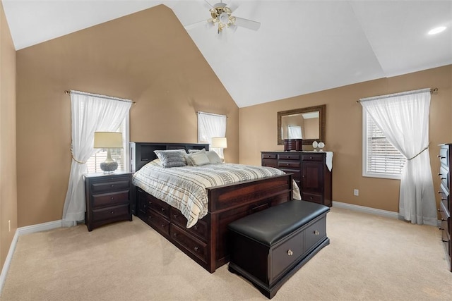 bedroom with a ceiling fan, light carpet, baseboards, and multiple windows