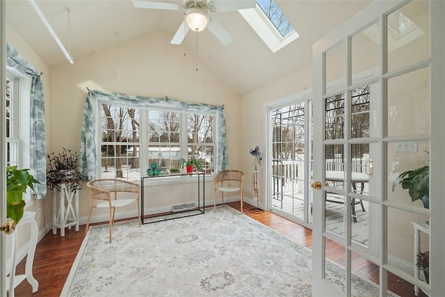 sunroom / solarium with lofted ceiling with skylight, visible vents, and ceiling fan