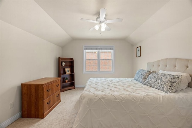 bedroom featuring baseboards, vaulted ceiling, and light colored carpet