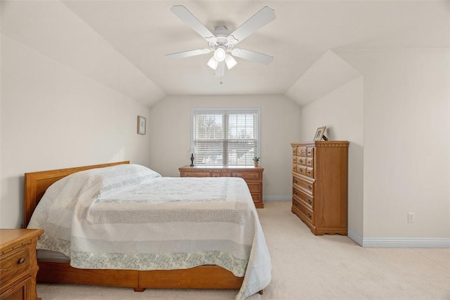 bedroom with light carpet, lofted ceiling, a ceiling fan, and baseboards