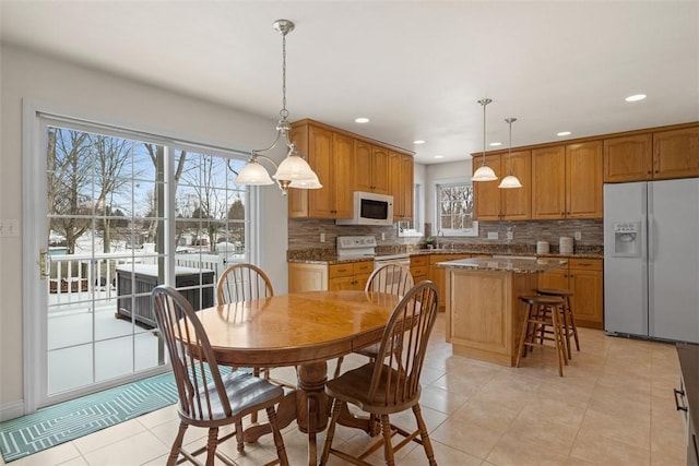 dining space featuring light tile patterned floors and recessed lighting