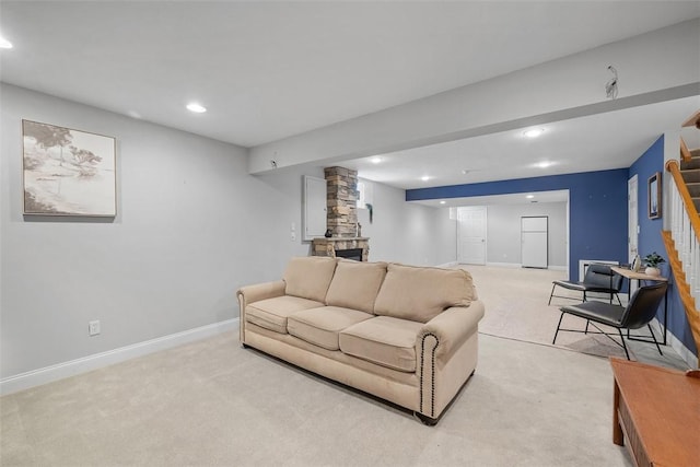 living room featuring recessed lighting, light colored carpet, baseboards, and stairs