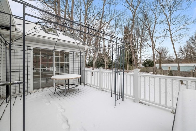 snowy yard featuring a deck