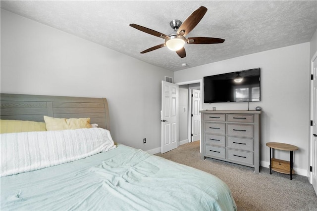 bedroom featuring visible vents, light carpet, a textured ceiling, and baseboards