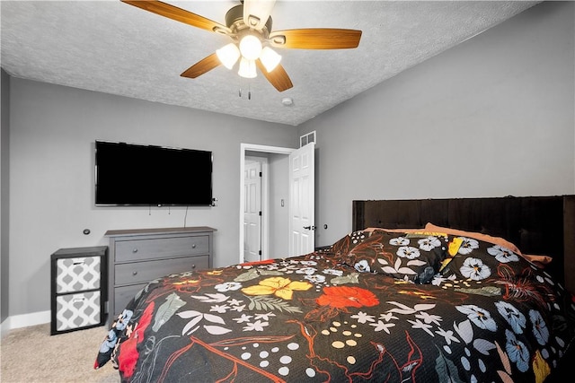 bedroom featuring a textured ceiling, ceiling fan, light colored carpet, visible vents, and baseboards