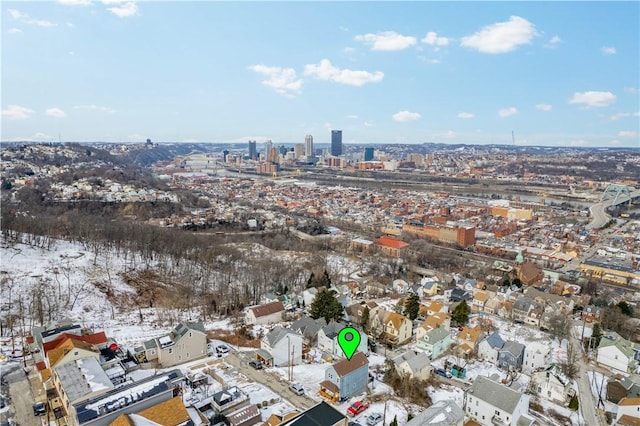 snowy aerial view with a view of city