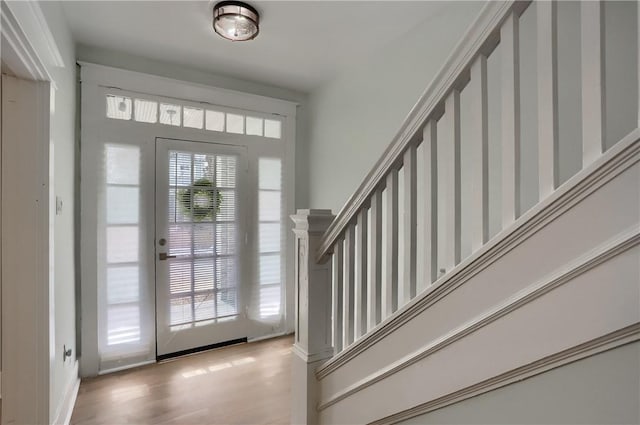 foyer featuring light wood finished floors and stairs