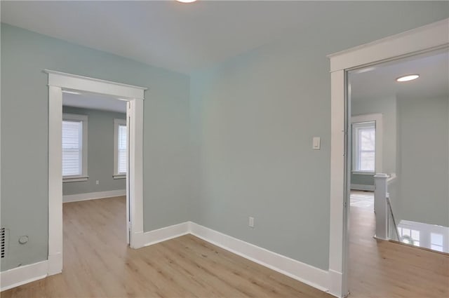 unfurnished room featuring light wood finished floors and baseboards