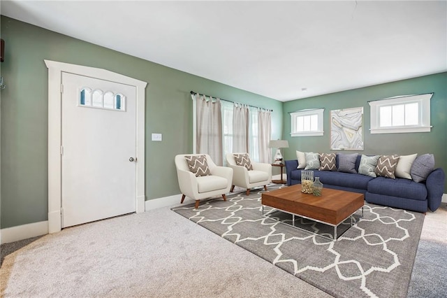 living area with baseboards and carpet flooring