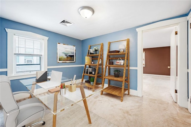 home office featuring visible vents, light carpet, and baseboards