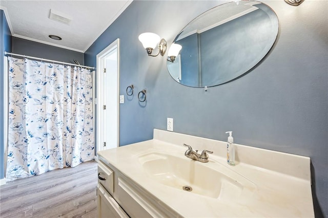 full bath with a shower with shower curtain, wood finished floors, crown molding, and vanity