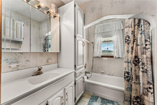 full bath featuring tile walls, vanity, tile patterned floors, tasteful backsplash, and shower / bathtub combination with curtain