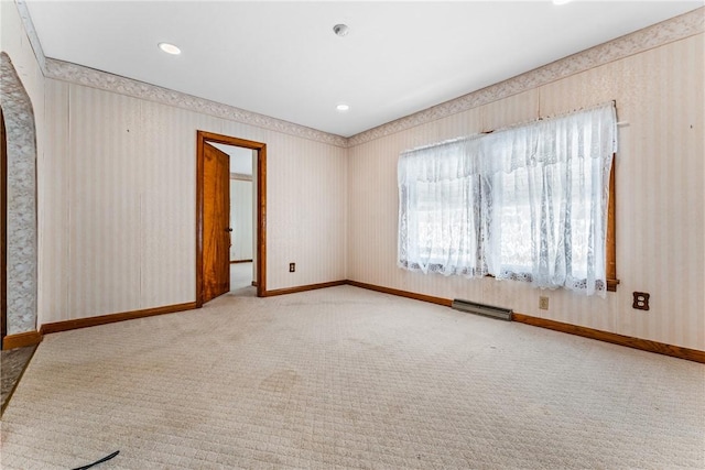 unfurnished room with light carpet, visible vents, baseboards, and wallpapered walls