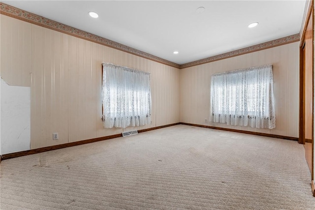 unfurnished room with recessed lighting, baseboards, visible vents, and light colored carpet