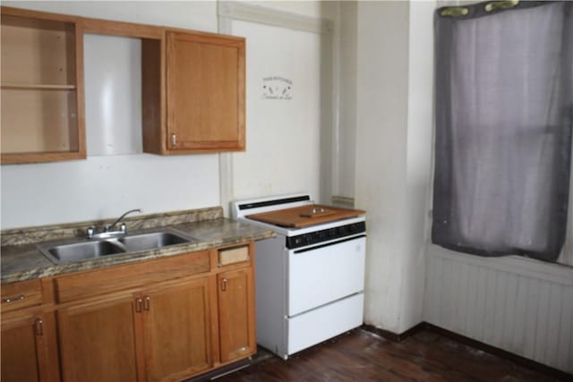 kitchen with white range with electric stovetop, dark wood finished floors, brown cabinets, and a sink