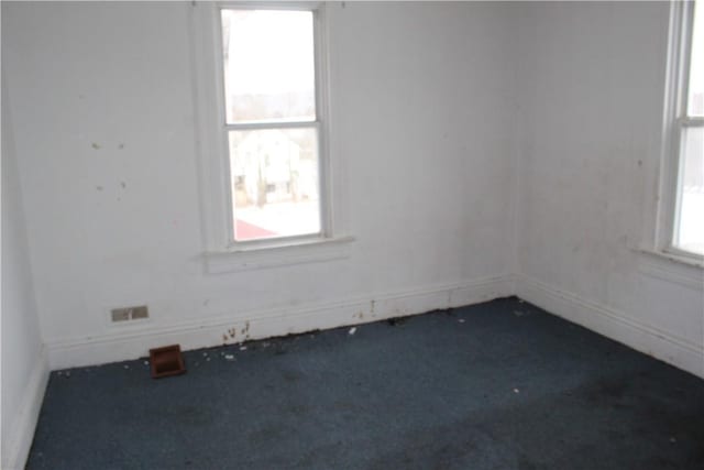 empty room featuring dark colored carpet