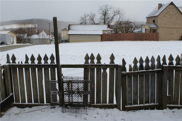 yard covered in snow with fence