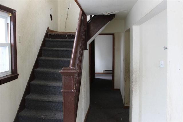 stairs with a baseboard radiator