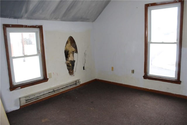 additional living space with a baseboard radiator, dark carpet, and baseboards