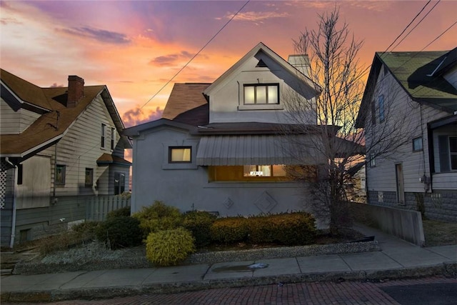 view of front of property with fence and stucco siding