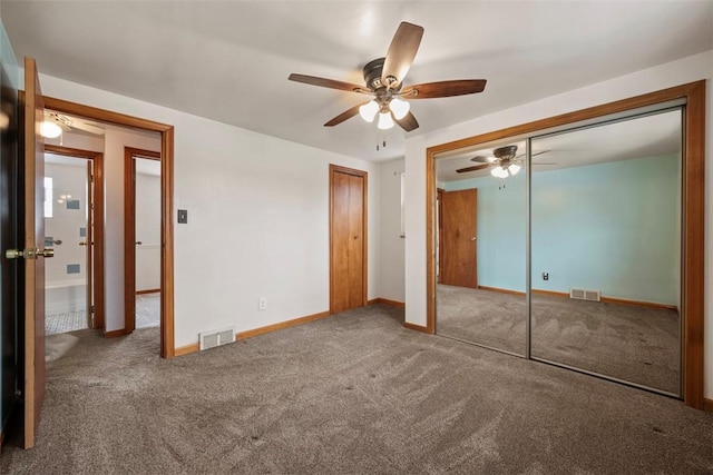 unfurnished bedroom with carpet floors, visible vents, and baseboards