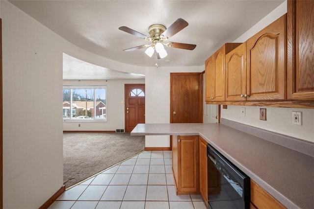 kitchen featuring light tile patterned floors, light carpet, a peninsula, black dishwasher, and light countertops