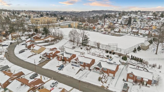 snowy aerial view featuring a residential view