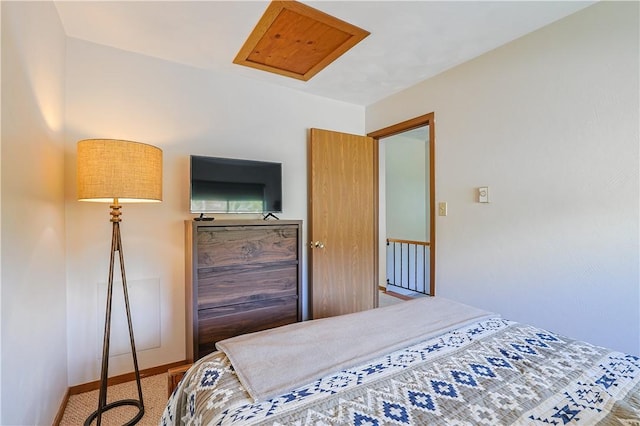 carpeted bedroom featuring baseboards