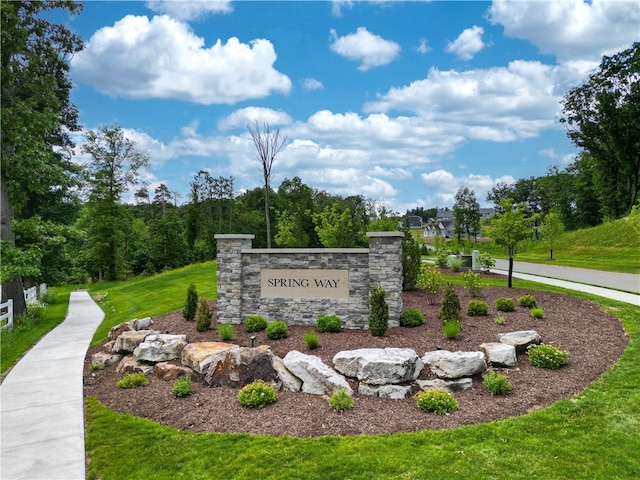 community sign featuring a lawn