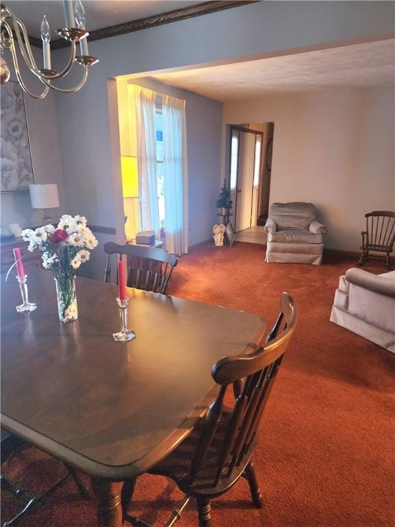 dining room featuring an inviting chandelier and carpet