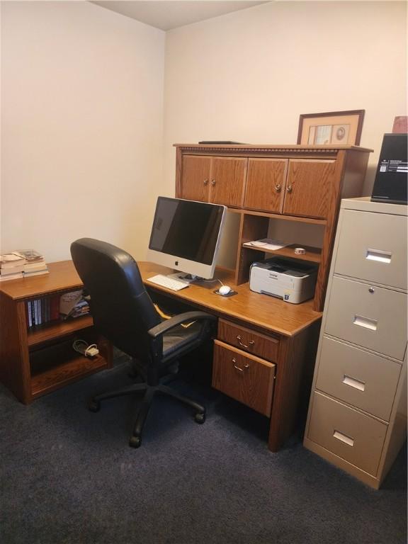 office space with dark colored carpet