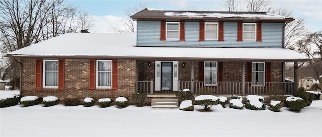 view of front facade featuring a porch and brick siding