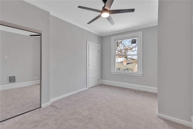 unfurnished bedroom with baseboards, visible vents, and light colored carpet