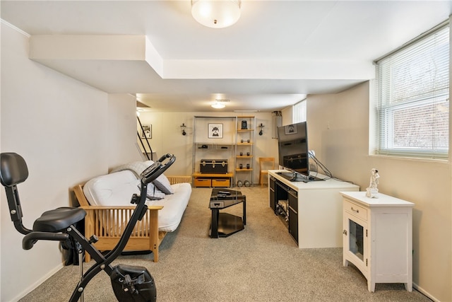 workout area with light carpet and baseboards