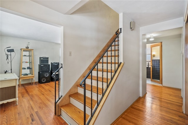 stairway featuring wood finished floors