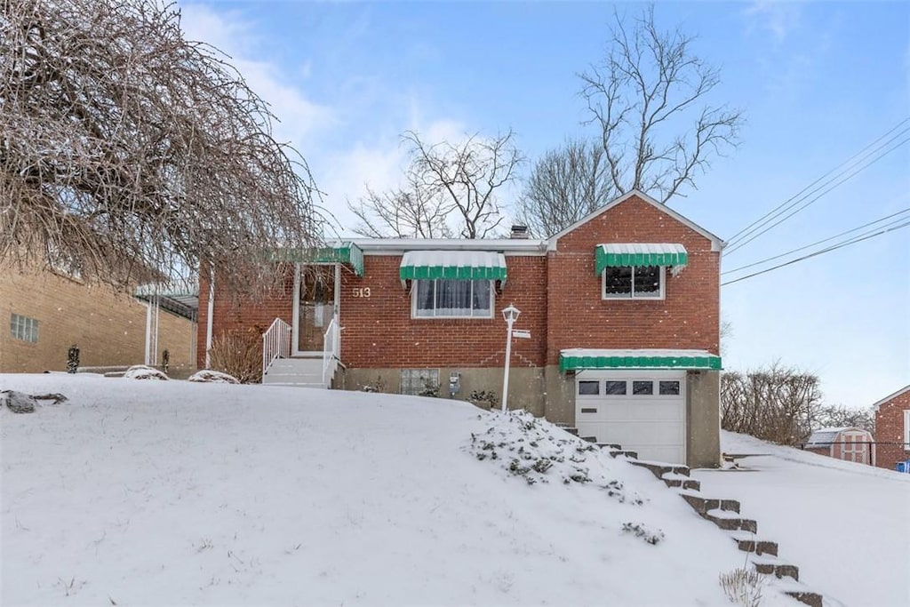view of front facade featuring a garage and brick siding