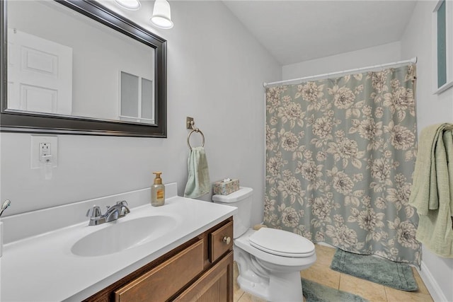 full bathroom featuring toilet, vanity, and tile patterned floors