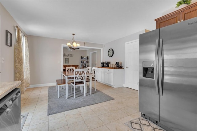 dining space with a notable chandelier, baseboards, and light tile patterned floors