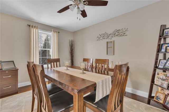 dining room with ceiling fan, wood finished floors, and baseboards