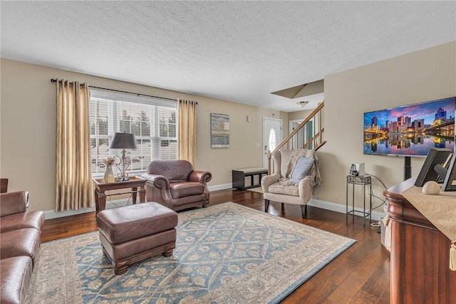 living area with stairs, a textured ceiling, baseboards, and dark wood-style flooring