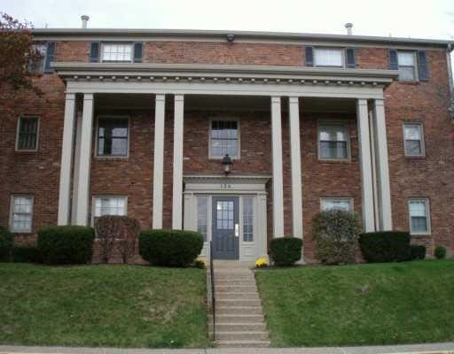 view of front of home with brick siding and a front lawn