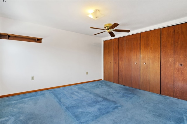 unfurnished bedroom with carpet, a ceiling fan, and baseboards