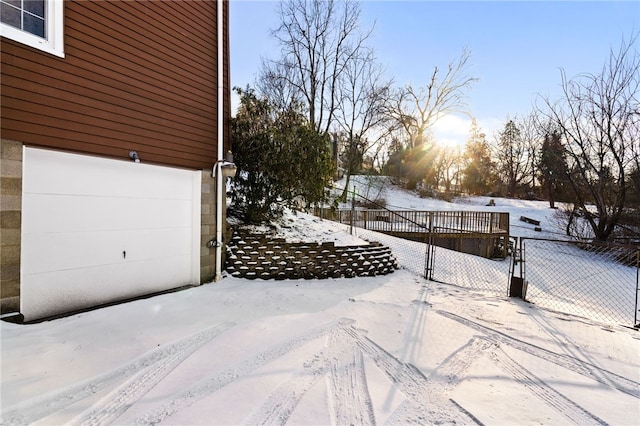 snowy yard featuring fence