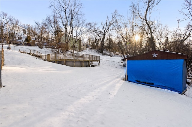 snowy yard featuring a deck