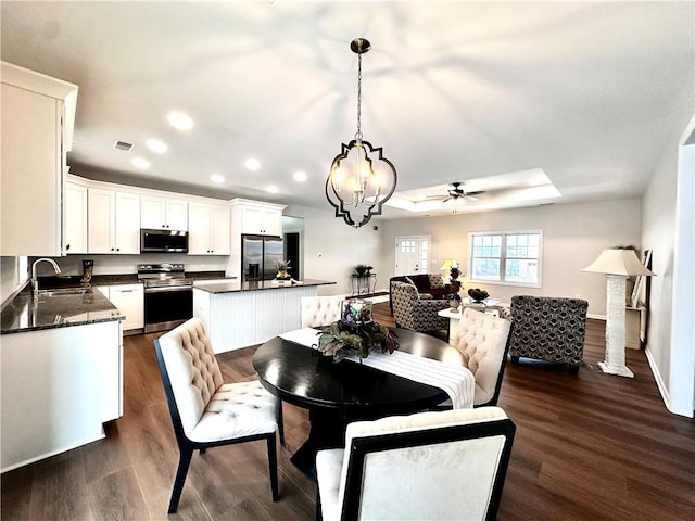 211 Ruby Dr, Menallen Twp, PA 15401 - dining area with visible vents, dark wood-style flooring, baseboards, recessed lighting, and ceiling fan with notable chandelier