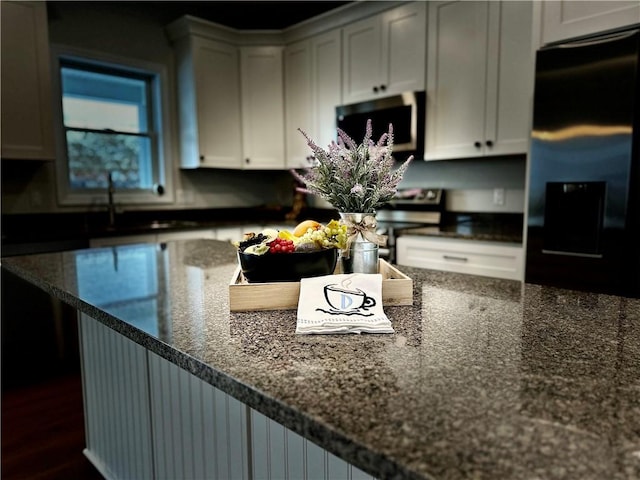 211 Ruby Dr, Menallen Twp, PA 15401 - kitchen with dark stone counters, appliances with stainless steel finishes, dark wood-style flooring, and white cabinetry