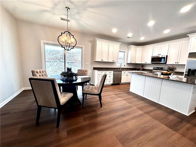 211 Ruby Dr, Menallen Twp, PA 15401 - kitchen with dark countertops, recessed lighting, white cabinets, a chandelier, and stainless steel appliances