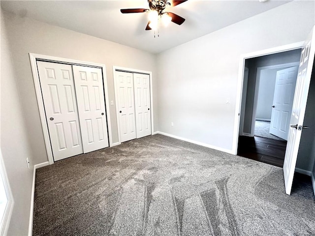 211 Ruby Dr, Menallen Twp, PA 15401 - unfurnished bedroom with two closets, a ceiling fan, baseboards, and carpet